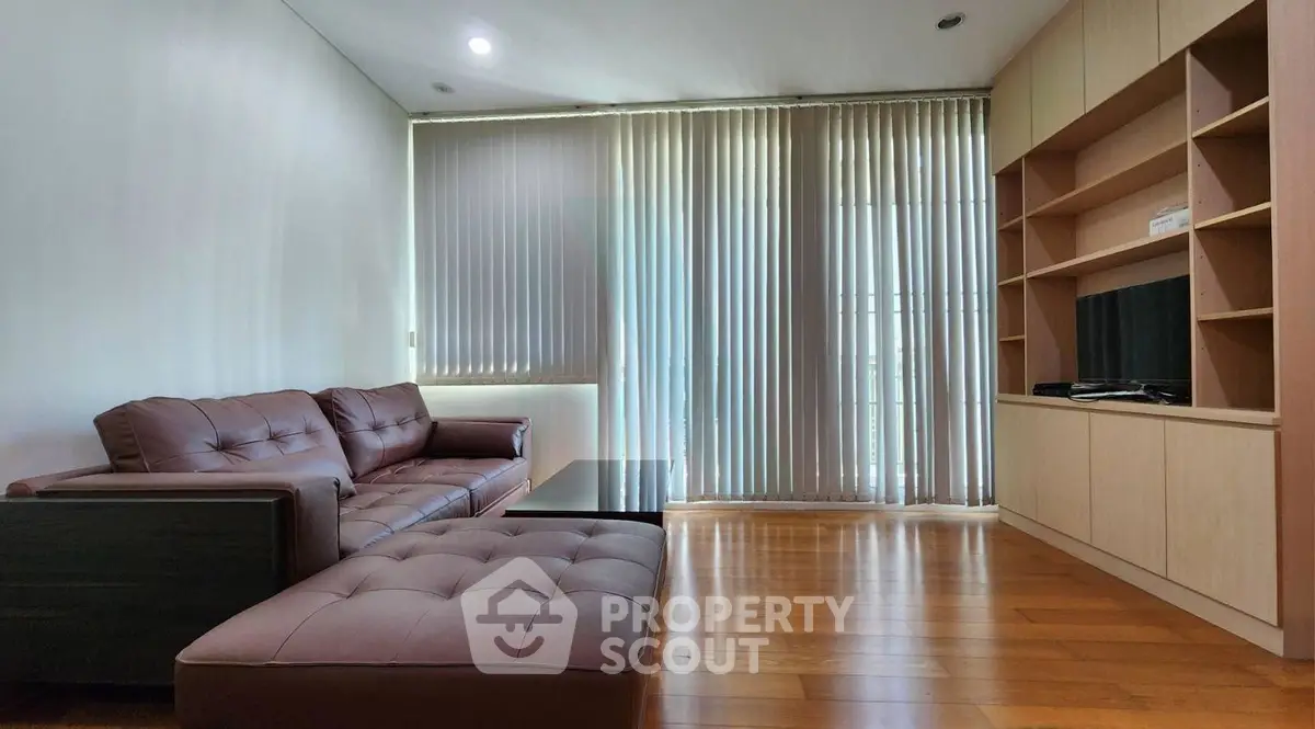 Modern living room with sleek furniture and floor-to-ceiling windows
