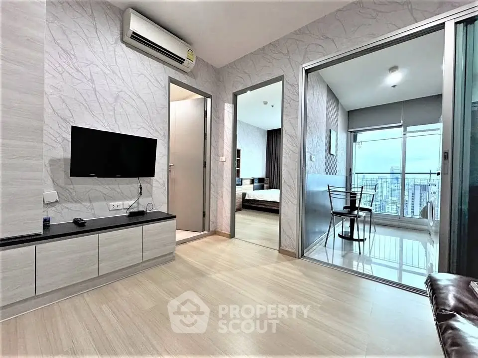 Modern apartment interior with open layout, featuring a living room and balcony with city view.