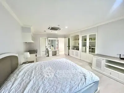 Spacious bedroom with elegant built-in storage and modern decor