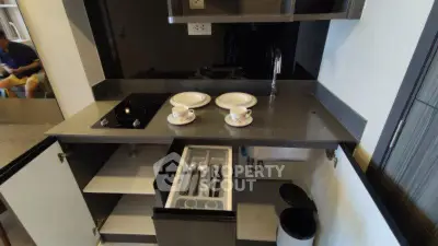 Compact modern kitchen with open cabinets and sleek countertop