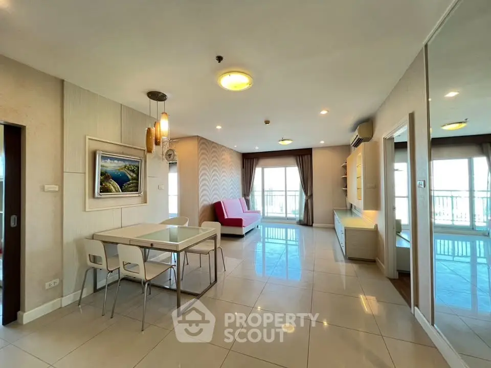 Spacious modern living room with elegant decor and large windows offering natural light.