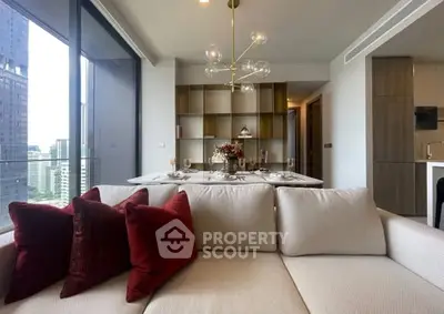 Modern living room with elegant decor and city view from large windows.