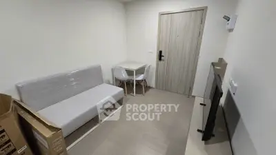 Compact modern living room with minimalist furniture and neutral tones, ideal for urban living.