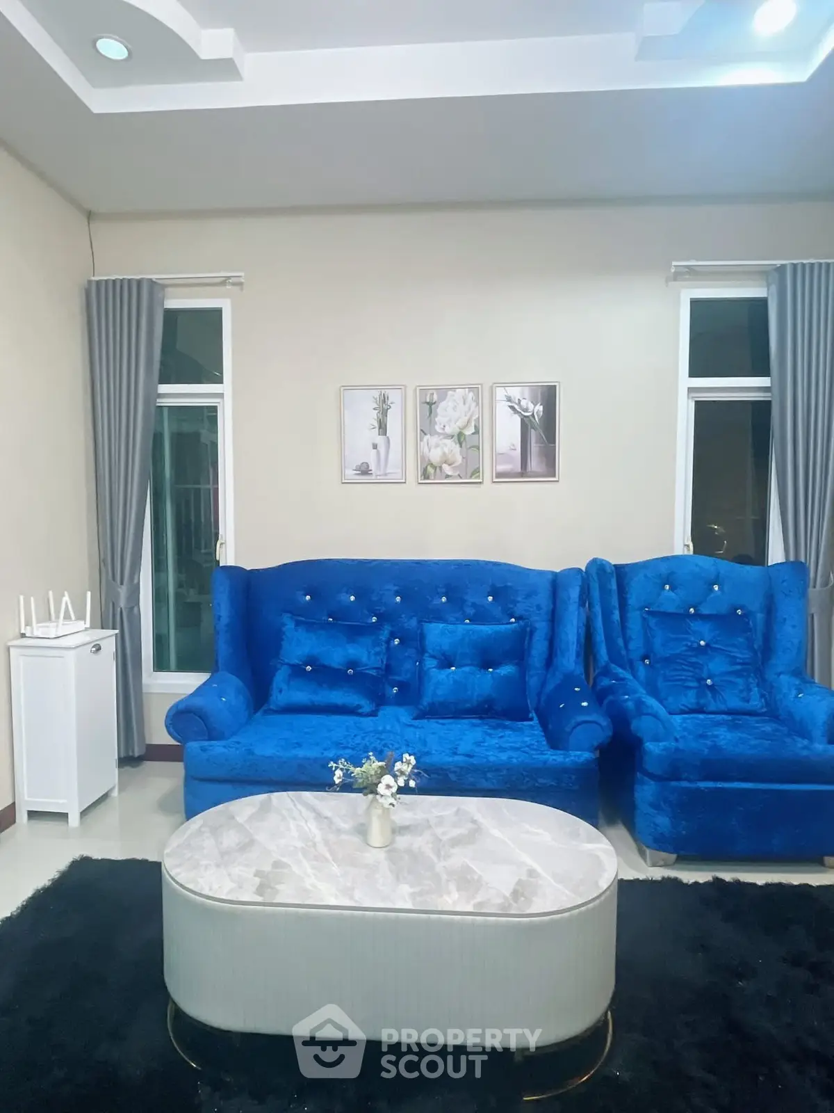 Elegant living room with plush blue sofas and modern decor