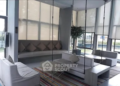 Modern living room with stylish furniture and large windows offering natural light.