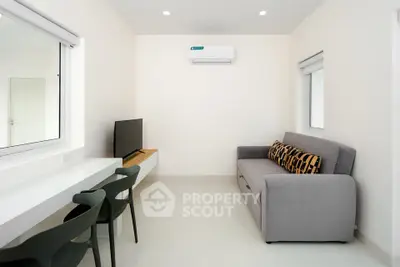 Modern living room with sleek furniture and air conditioning, perfect for a cozy urban lifestyle.