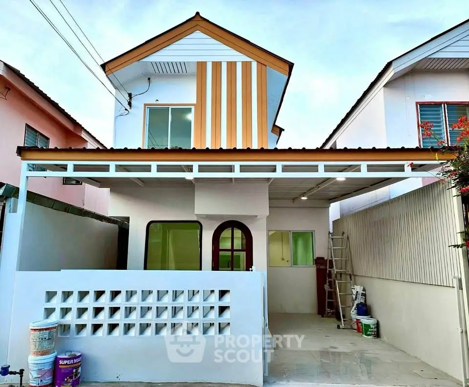 Charming two-story house with modern facade and spacious driveway.