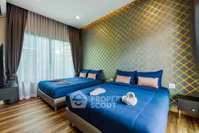 Luxurious bedroom with elegant decor and twin beds, featuring stylish wallpaper and wooden flooring.