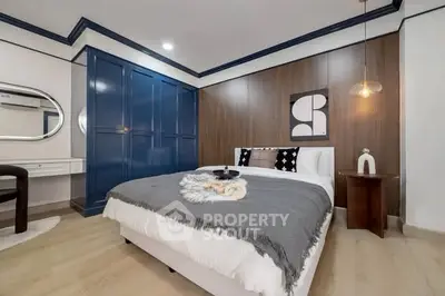 Stylish modern bedroom with blue wardrobe and elegant decor