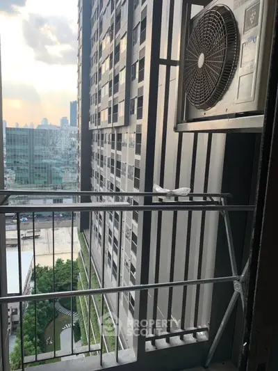 High-rise apartment balcony with city view and air conditioning unit