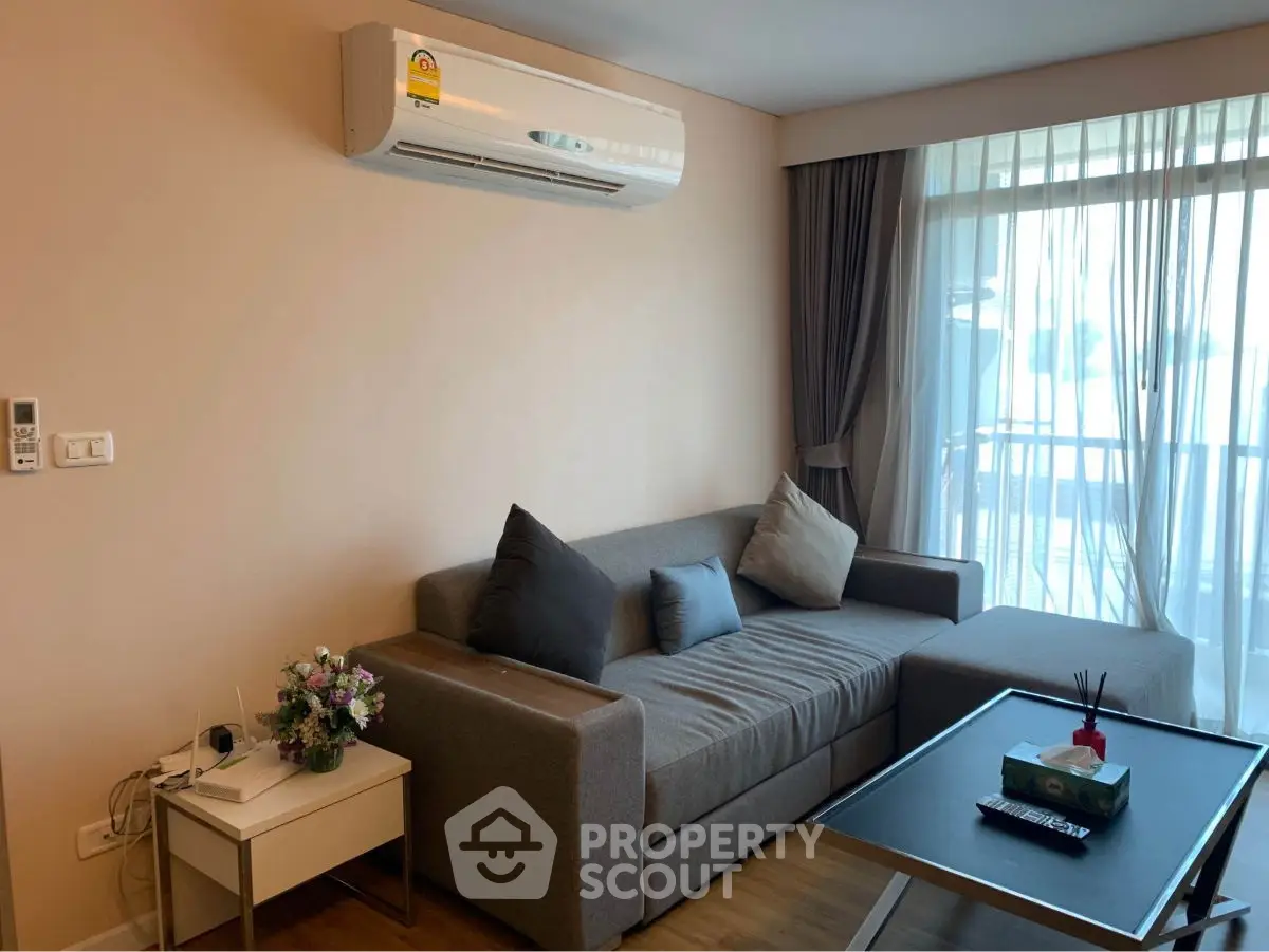 Modern living room with cozy sofa and balcony view