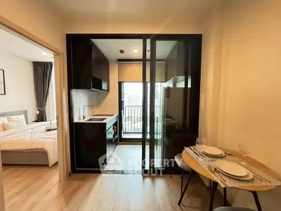 Modern apartment with open kitchen and cozy dining area, featuring a balcony view and elegant bedroom.
