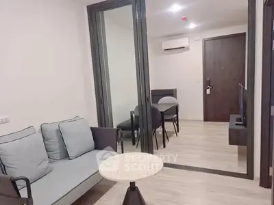 Modern living room with glass partition and stylish furniture in a contemporary apartment.