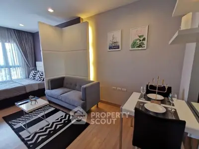 Modern studio apartment with stylish decor, featuring a cozy living area and dining space, perfect for urban living.