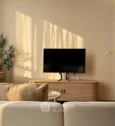 Stylish living room with modern TV setup and elegant furniture, perfect for cozy relaxation.