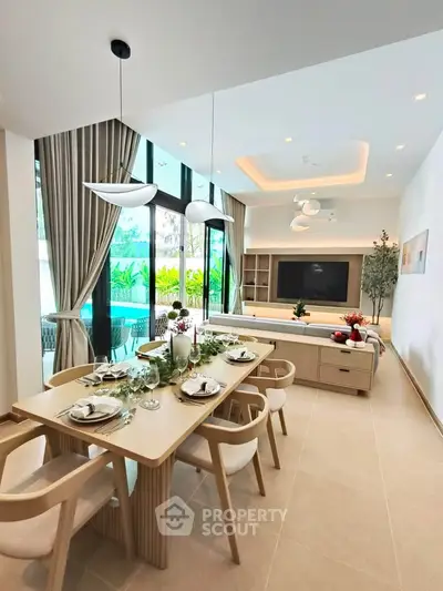 Luxurious open-plan living room with elegant dining area and pool view, perfect for modern living.