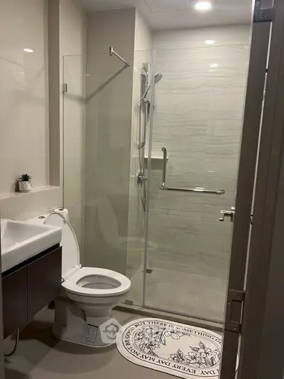 Modern bathroom with glass shower and sleek fixtures in a contemporary home.