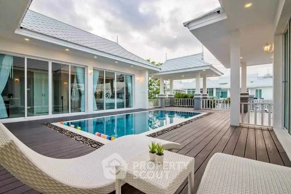 Luxurious modern villa with private pool and spacious deck area, perfect for relaxation and entertainment.