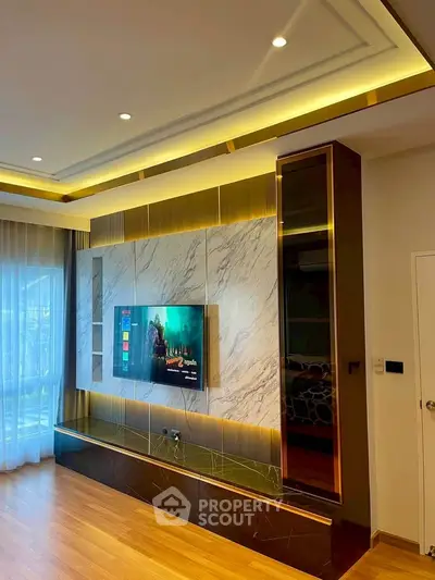 Luxurious living room with modern TV setup and elegant lighting