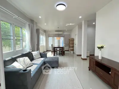 Spacious living room with modern decor and large windows for natural light.