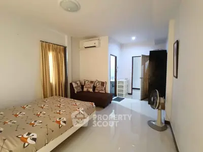 Cozy bedroom with modern decor and air conditioning in a bright apartment.
