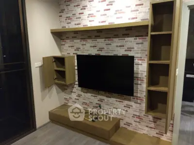 Modern living room with wall-mounted TV and stylish brick accent wall