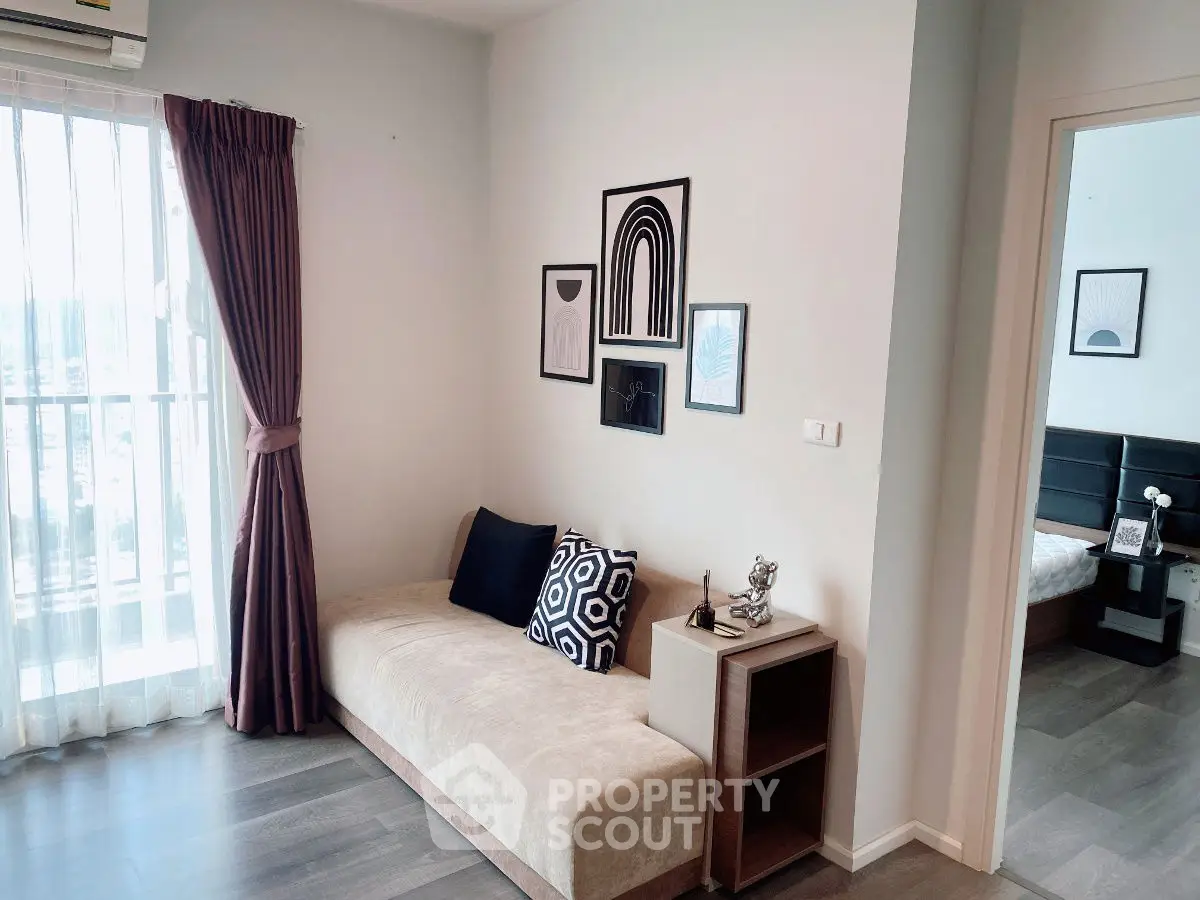 Stylish living room with modern decor and cozy seating in a bright apartment.