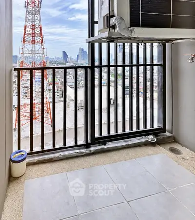 High-rise balcony with cityscape view and air conditioning unit, perfect for urban living.