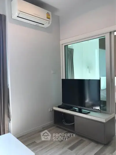 Modern living room with air conditioning and sleek TV setup