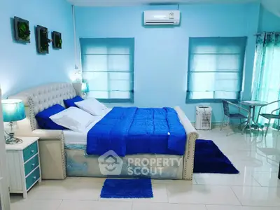 Spacious bedroom with elegant decor and cozy blue accents