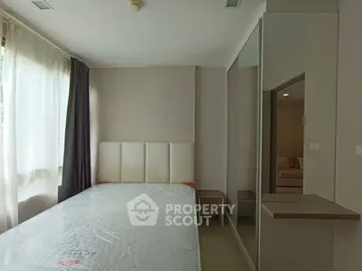 Modern bedroom with large window and mirrored wardrobe
