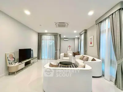 Luxurious modern living room with elegant white furniture and large windows