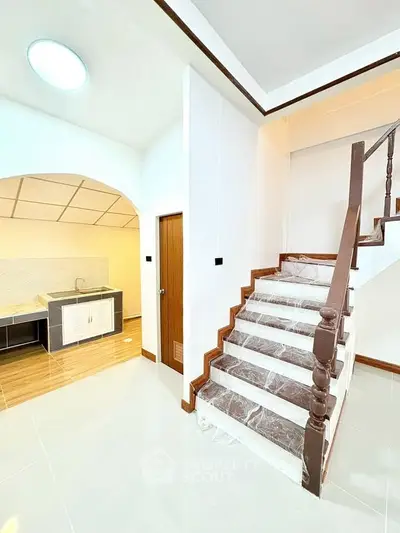 Bright interior with modern staircase and open kitchen layout