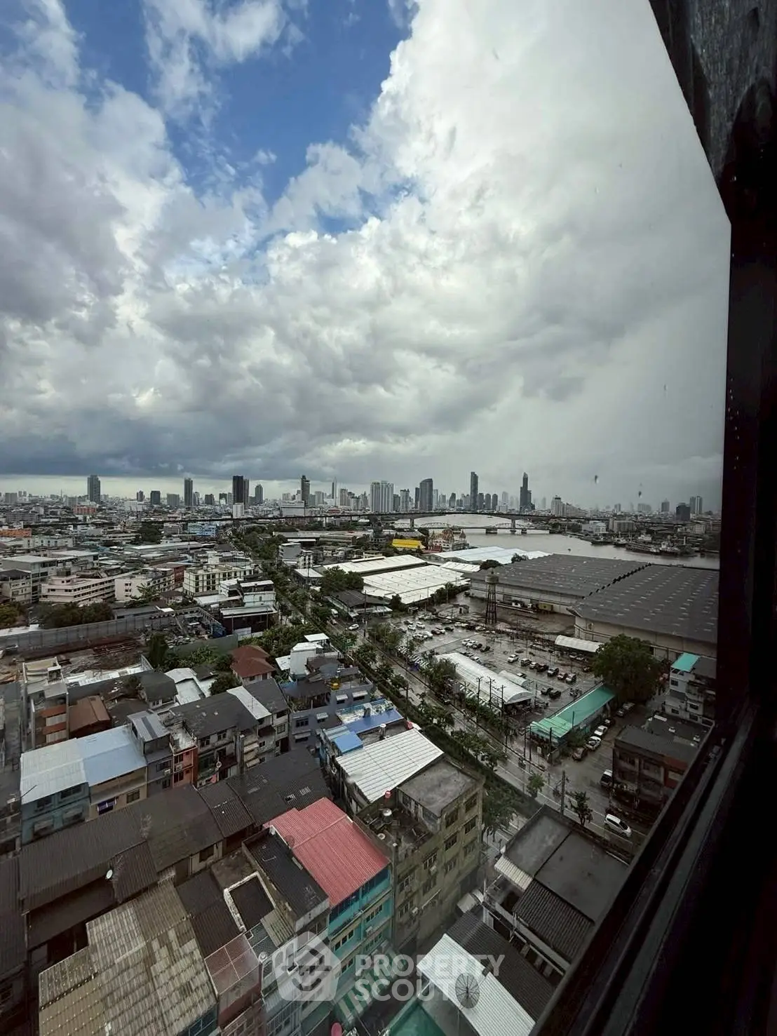 Stunning cityscape view from high-rise window showcasing urban skyline and expansive horizon.
