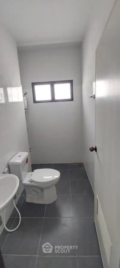 Compact bathroom with modern fixtures and natural light