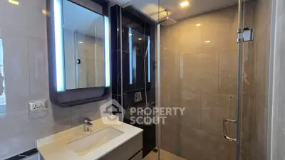 Modern bathroom with sleek design and illuminated mirror