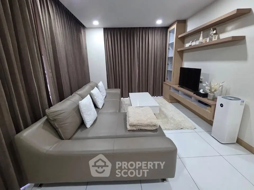 Modern living room with sleek leather sofa and entertainment center