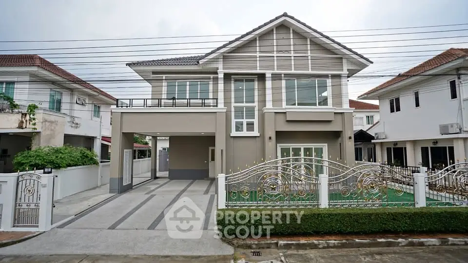 Elegant two-story house with modern facade and spacious driveway in suburban neighborhood.