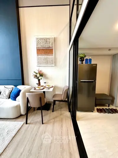 Modern open-plan living and dining area with stylish decor and sleek kitchen appliances.
