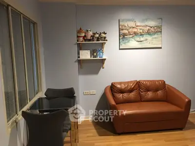 Cozy living room with brown leather sofa and decorative shelf, perfect for relaxation.
