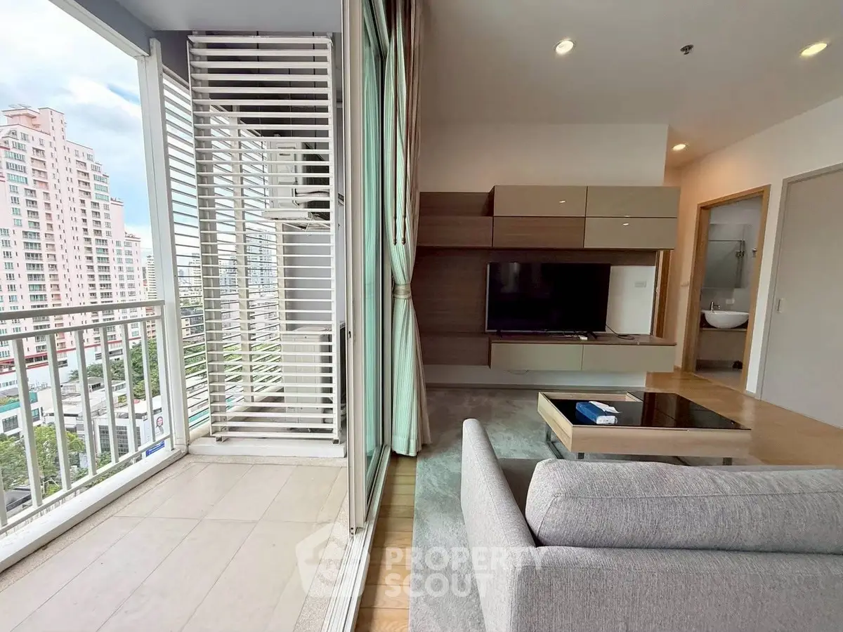 Modern living room with balcony view in high-rise apartment