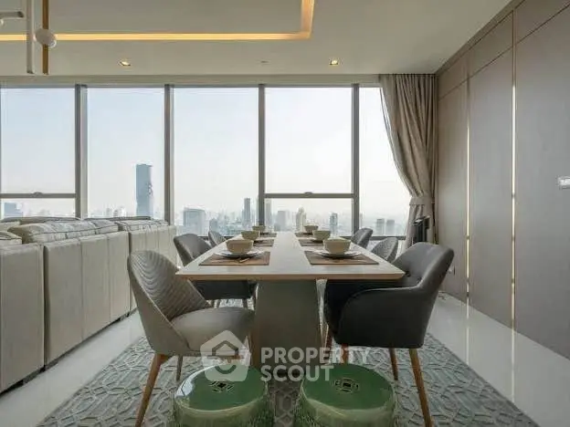 Luxurious dining area with panoramic city views and elegant decor in a high-rise apartment.