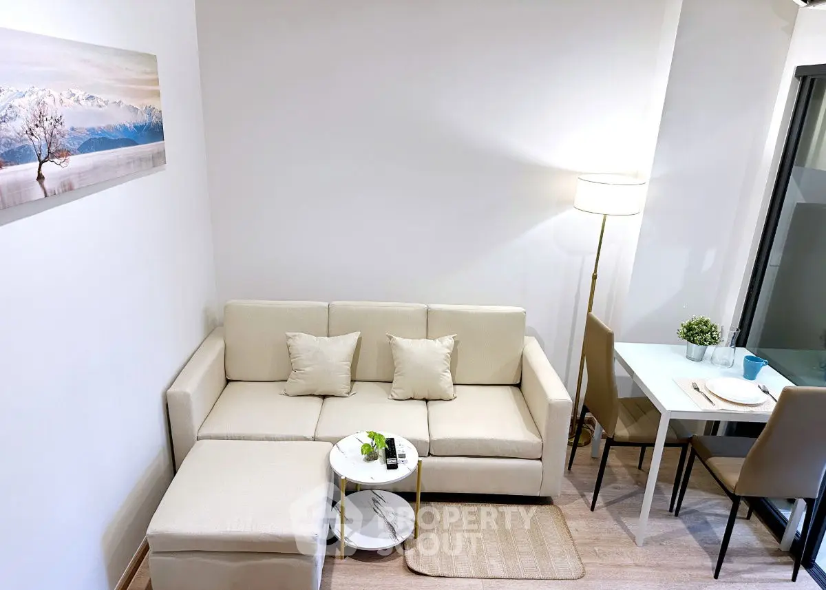 Chic and cozy living room with modern beige sofa and dining area, perfect for urban living.