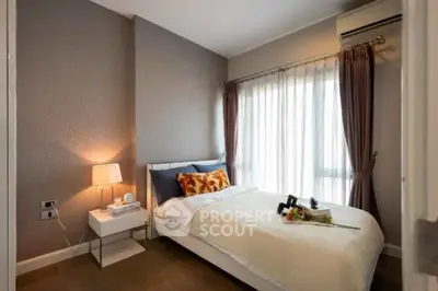 Cozy bedroom with elegant decor and natural light, featuring a comfortable bed and stylish accents.