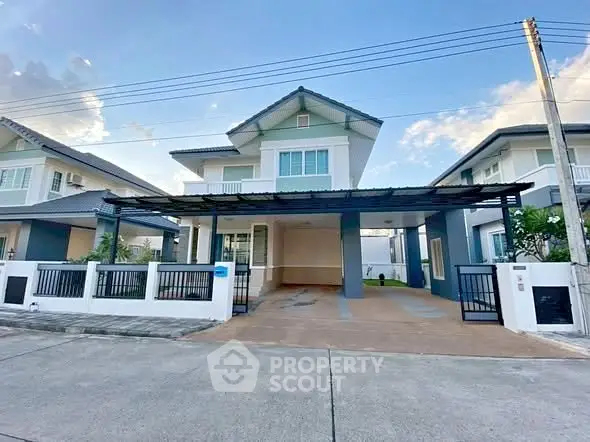 Modern two-story house with spacious driveway and contemporary design.
