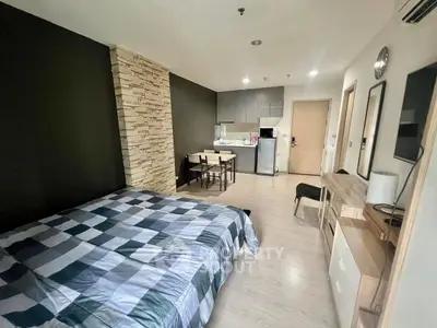 Modern studio apartment with stylish decor and compact kitchen