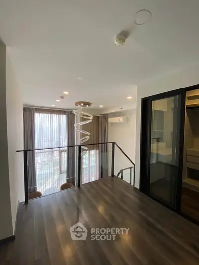Modern duplex interior with spiral staircase and city view