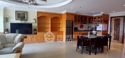 Spacious open-plan living room with elegant wooden cabinetry and modern kitchen.