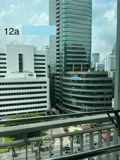 Stunning cityscape view from a high-rise balcony with modern skyscrapers.