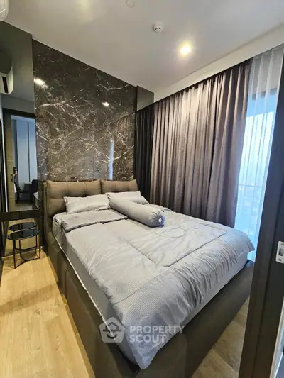 Luxurious bedroom with modern decor and floor-to-ceiling curtains